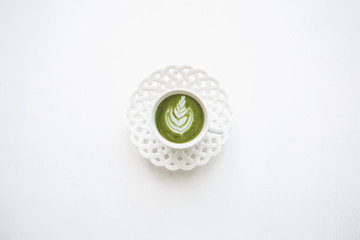 Fresh useful green matcha latte coffee in a beautiful mug on a white background.