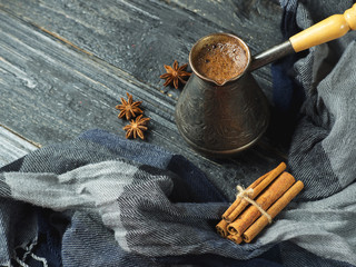 Turk brewed black coffee on a wooden table with cinnamon