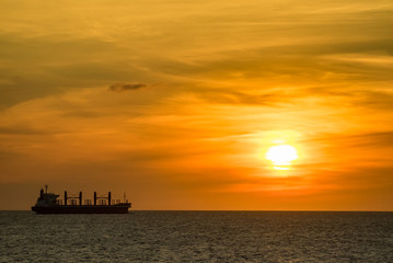 A ship sailing past as the sun sets on the Caribbean island of Curacao