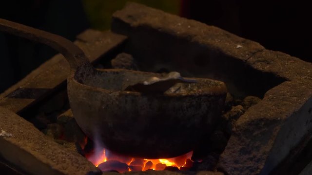 Production of antique coin during a reenactment at Breno (Italy) on August 12, 2018. 