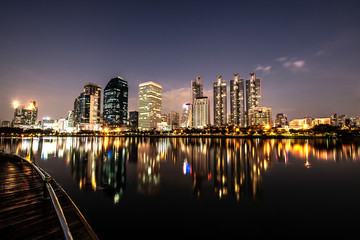 Fototapeta na wymiar Modern night city skyline with lights reflection