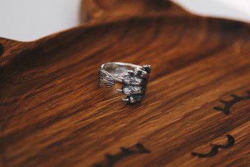 Silver ring on wooden slice