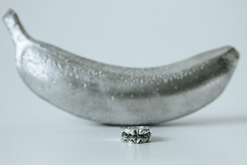 Obraz na płótnie Canvas Ape shape silver ring in front of banana