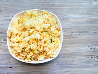 top view of Fried Rice in bowl on gray wood board