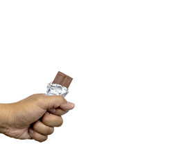 hand holding a bar of milk chocolate on white background.