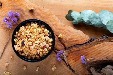 Food breakfast concept Organic Muesli or Granola on black ceramic cup