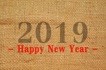 Happy New Year 2019 text isolated on sack background.