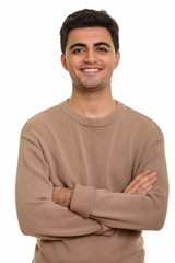 Fototapeta premium Young happy Persian man smiling and looking at camera
