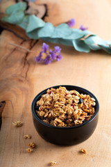 Food breakfast concept Organic Muesli or Granola on black ceramic cup