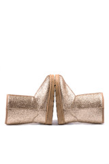 Female winter boots of golden color on white background