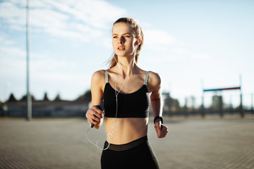 Early morning workout. Happy Beautiful women running in the headphones. Living healthy lifestyle.