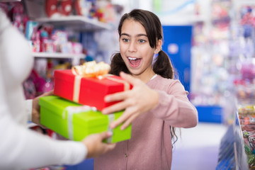 Portrait of small woman receives gifts with emotion