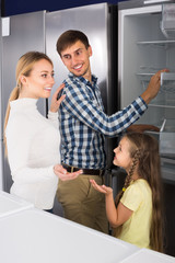 Smiling family selecting refrigerator