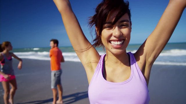 Portrait of Latin American female enjoying exercise on the beach