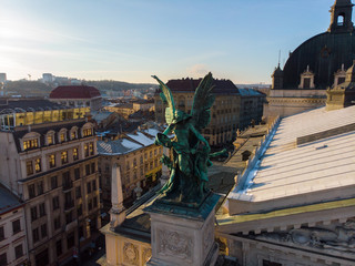 statue on roof of old european building on sunset