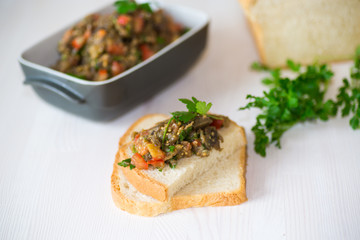eggplant caviar with tomatoes and a slice of bread