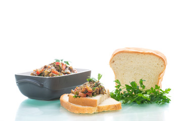 eggplant caviar with tomatoes and a slice of bread