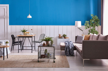 Bleu and white living room. grey sofa grey metal table and wooden dining table style.