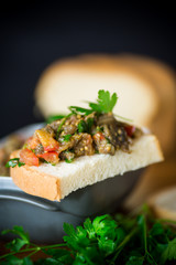 eggplant caviar with tomatoes and a slice of bread