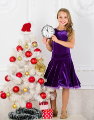 How much time left. Last minute till midnight. New year countdown. Last minute new years eve plans that are actually lot of fun. Girl kid santa hat costume with clock counting time to new year