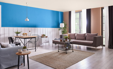 white and blue living room with grey sofa carpet and lamp.