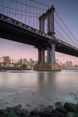 Fototapeta na wymiar View on Manhattan bridge from east river at sunrise