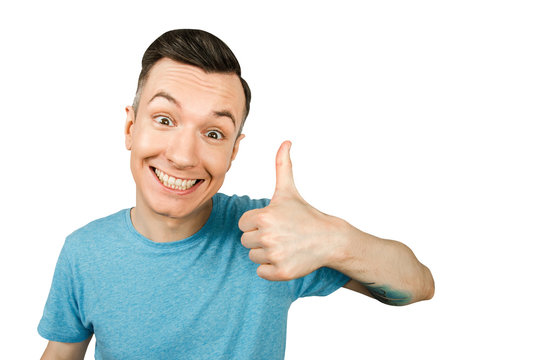 Portrait of young smiling guy showing thumb up isolated on a white background.