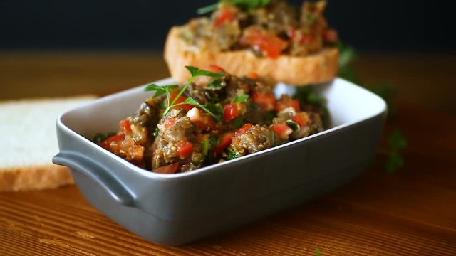 eggplant caviar with tomatoes and a slice of bread