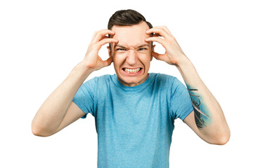 Portrait of young angry guy with hands at head isolated on a white background.