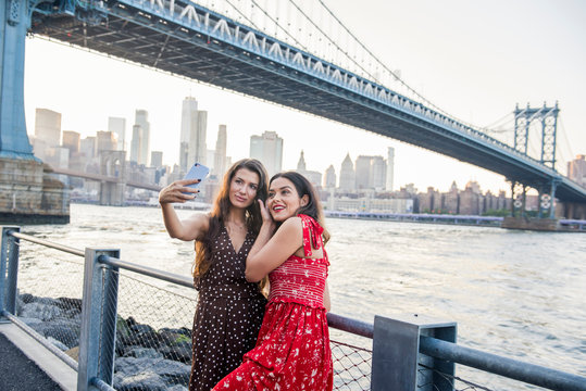 Two women taking a selfie by the Manhattan Bridge