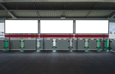 Obraz premium billboard big blank white three LED screen horizontal outstanding at side way people walking on sky train for display advertisement text template promotion new brand indoor.