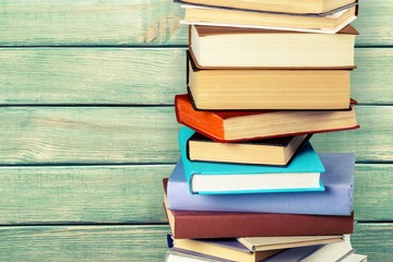 Colorful books collection on background.