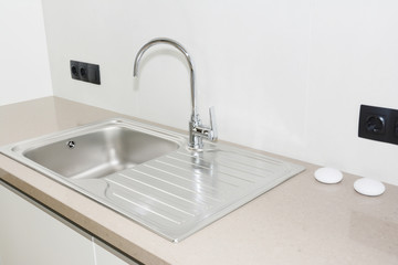Metal kitchen sink. Modern kitchen metal faucet and  metal kitchen sink.
