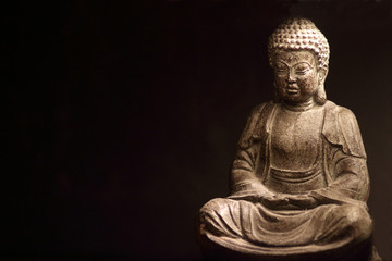 Statue of Buddha on dark background