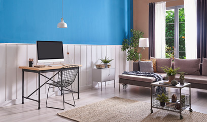 Grey sofa next to a grey sofa, metal coffee table and lamps in a living room interior. Real photo