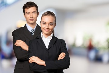 Young business couple in black suits in white office