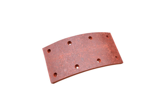 drilled brake lining pads of a truck on an isolated white background