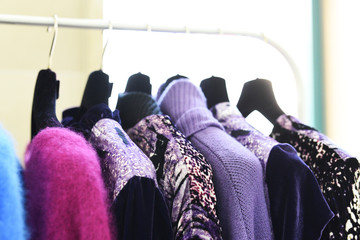 Colorful clothes on hangers