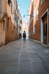 Narrow street in old town (Venice - Italy)