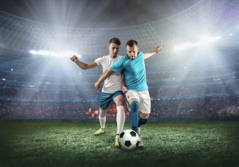 Soccer player on a football field in dynamic action at summer day