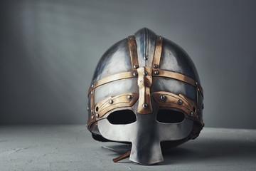 Knight's helmet on a gray background - obrazy, fototapety, plakaty