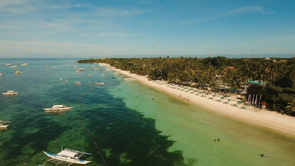 Aerial view of tropica Alona beach on the island Bohol, resort, hotels, Philippines. Beautiful tropical island with sand beach, palm trees. Tropical landscape. Seascape: Ocean, sky, sea. Travel