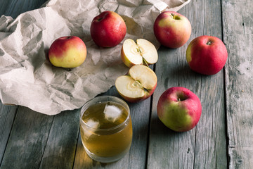 A glass of apple juice and fresh apples