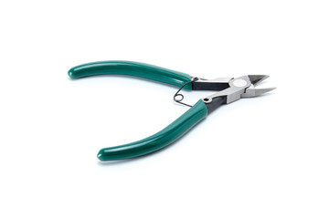 Medium-sized side cutters with green isolated handles on white background. Tool isolated on white, side view.