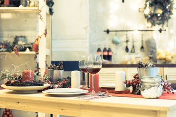 Christmas, holidays and table setting concept - wine glass and tableware for festive