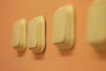 white light switches on light orange wall