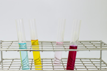 Liquid color in test tube place on rack isolated on the white background in the chemical laboratory