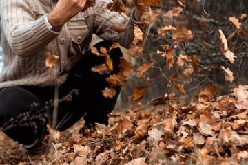 A bunch of autumn, yellow foliage on the ground, cleaning the leaves. Work in the garden. Concept autumn, yellow leaves, autumn mood. Copy space.