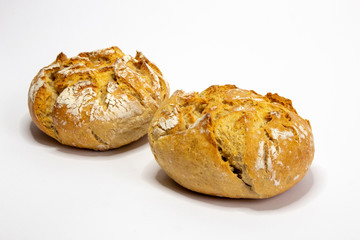 Two rustic bread rolls against white background