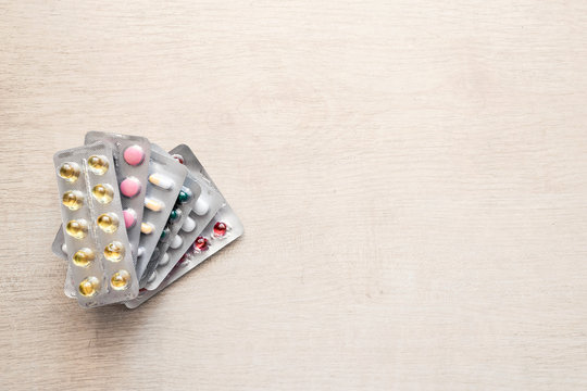 Pharmaceuticals antibiotics pills medicine mock up. Colorful antibacterials pills on wooden background.  Various capsule pill medicine
